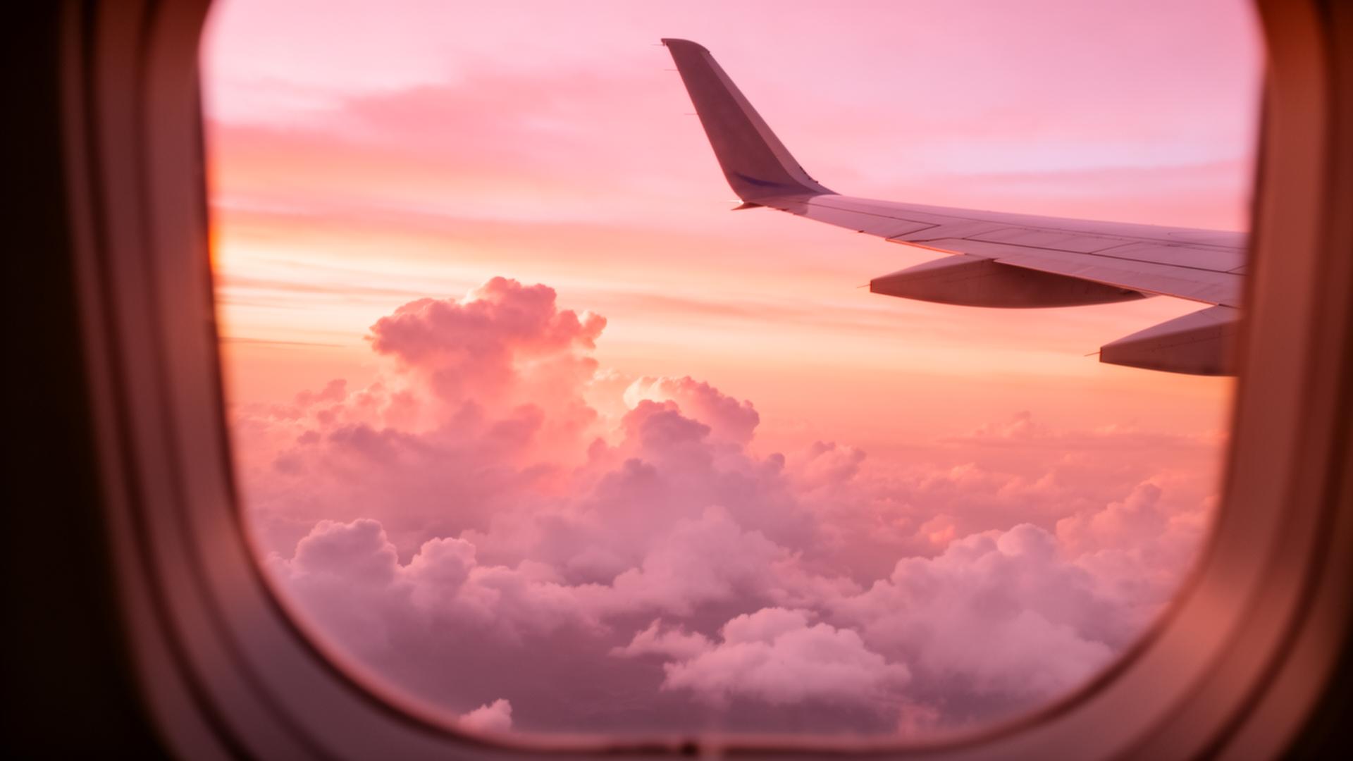 View of clouds at sunset from an airplane window